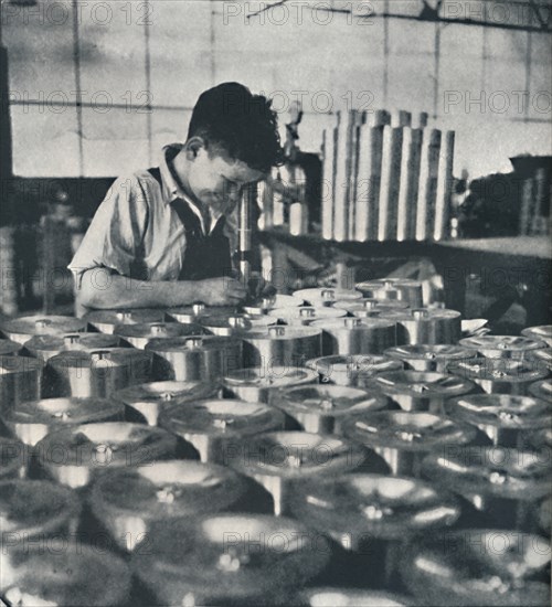 'Apprentice with microscope (testing the hardness of pistons)', 1941. Artist: Cecil Beaton.