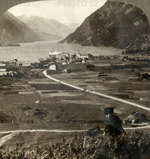 'Village roofs and sunny fields of Odde, N. up the narrow mountain-walled Sorfjord, Norway', 1905. Creator: Unknown.