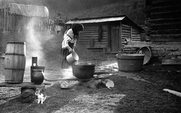 Woman pouring water into a pot, Bistrita Valley, Moldavia, north-east Romania, c1920-c1945. Artist: Adolph Chevalier