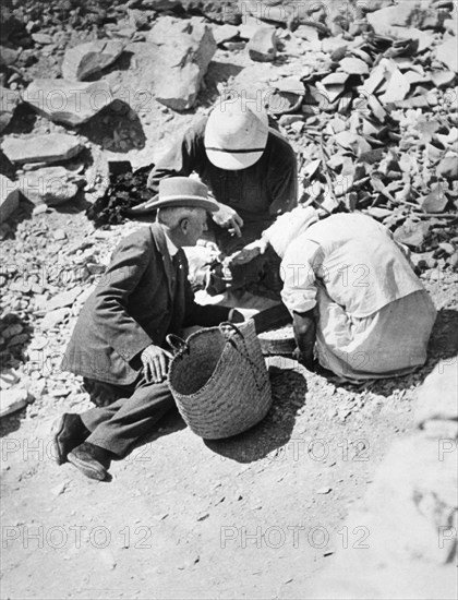 Sifting the dust from the floor of the Tomb of Tutankhamun, Valley of the Kings, Egypt, 1922. Artist: Harry Burton