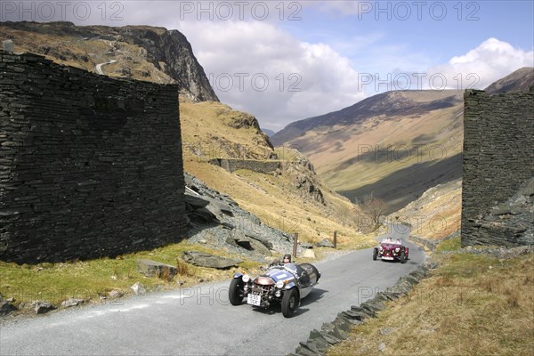 Vintage cars climbing Honister Pass, Lake District, Cumbria.