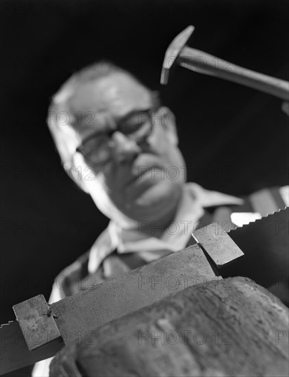 Setting the saw teeth on a hand saw blade, Sheffield, South Yorkshire, 1963. Artist: Michael Walters