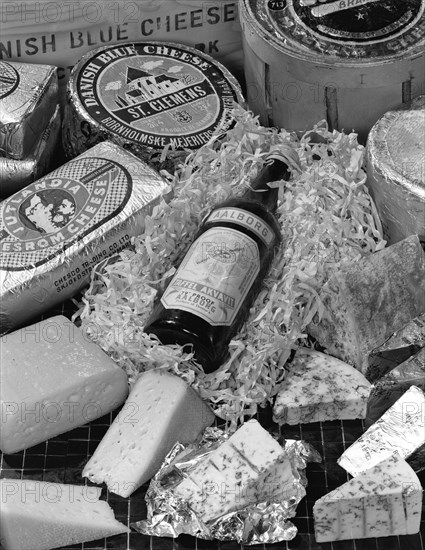 A selection of Danish cheeses and a bottle of Aalborg aquavit, 1963. Artist: Michael Walters