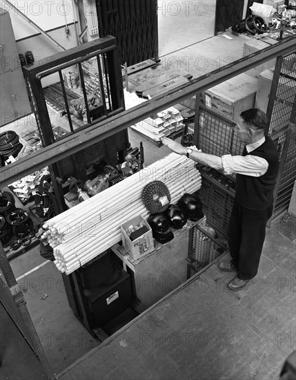 Warehouseman loading a fork lift truck in the stores, Bestwood Colliery, Nottinghamshire, 1962.  Artist: Michael Walters