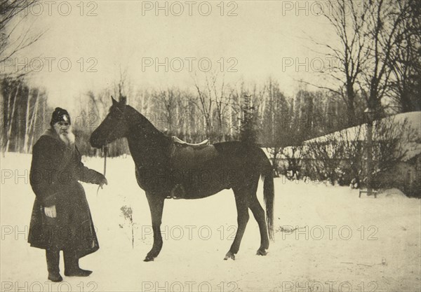 Russian author Leo Tolstoy with a horse, Yasnaya Polyana, near Tula, Russia, 1905.  Artist: Sophia Tolstaya