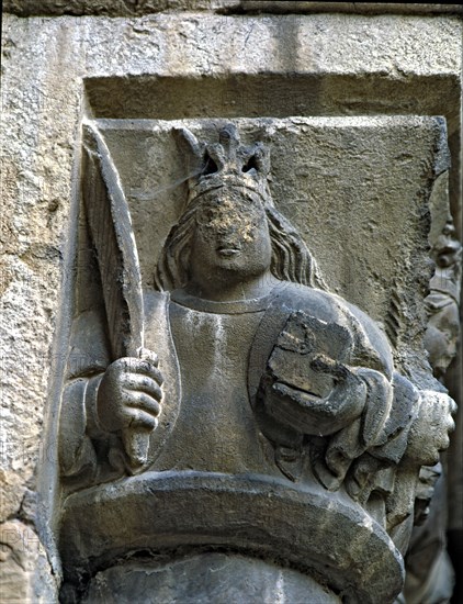 Capital of one of the Gothic galleries of the cloister built between (1387 - 1401) representing a?