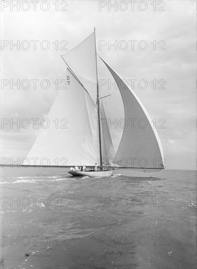 'Istria' sailing downwind under spinnaker, viewed from stern, 1912.  Creator: Kirk & Sons of Cowes.