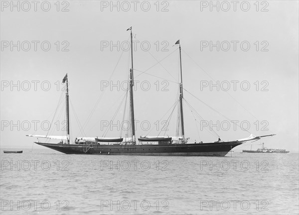 The three mast auxiliary sailing yacht 'Utopia' at anchor, 1913. Creator: Kirk & Sons of Cowes.