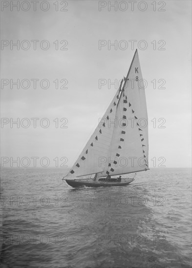 The 7 Metre sailing yacht 'Pinaster' (K8) with prize flags, 1912. Creator: Kirk & Sons of Cowes.