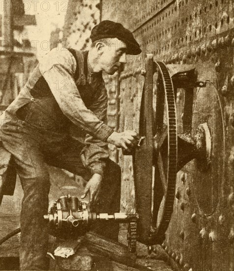 A Pneumatic Riveter Cutting Portholes in the Side of a Liner', c1930.