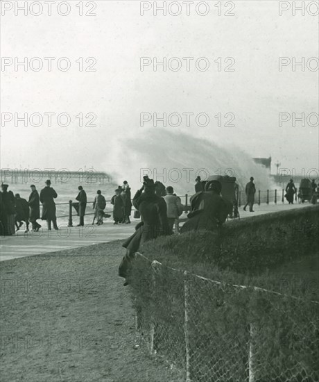 Rough sea over the promenade at Hastings, Sussex, late 19th-early 20th century.