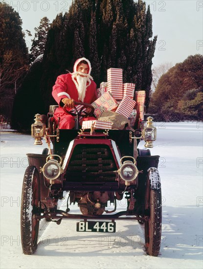 1901 Durkopp with Santa Claus delivering Christmas gifts. Creator: Unknown.