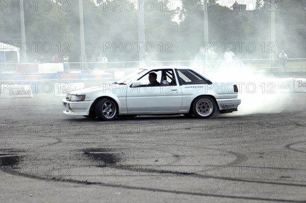 Smoking tyres during tyre burn-out. Creator: Unknown.