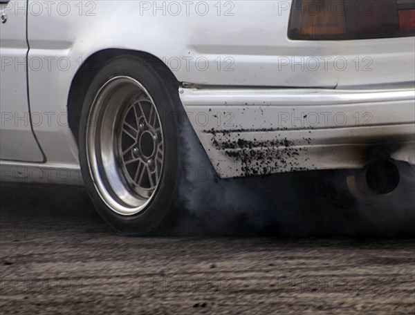 Smoking tyres during tyre burn-out. Creator: Unknown.