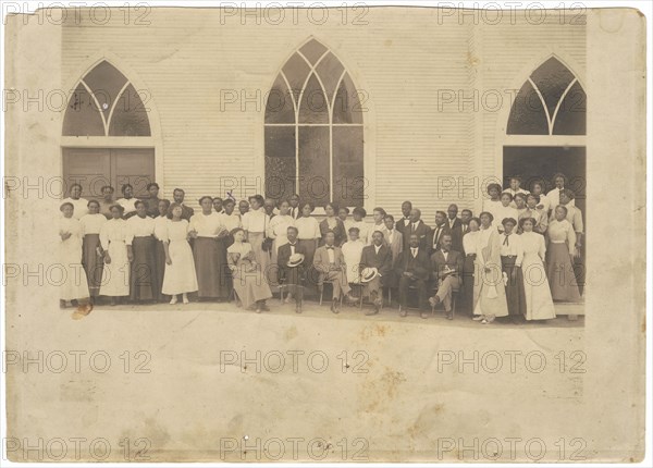 Photographic print of men and women in front of Vernon AME Church, Tulsa, ca. 1919. Creator: Unknown.