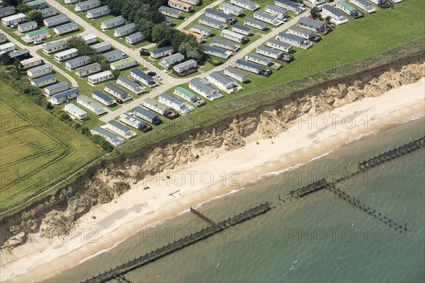 Coastal erosion between a caravan park and the sea defences at Corton Cliffs, Suffolk, 2019.