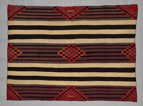 Chief Blanket (Third Phase), c. 1880. A work made of wool, plain weave with "lazy lines" and dovetail tapestry weave; warp and weft twining; corner tassles.