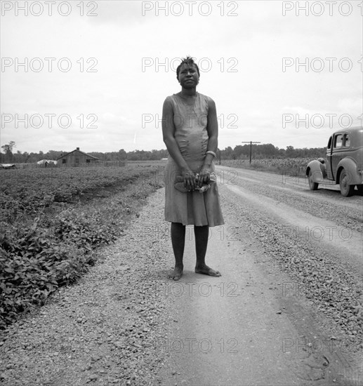Negro woman carrying her shoes home..., Mississippi Delta, 1936. Creator: Dorothea Lange.