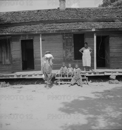 Negro wage laborer and part of his family, Macon County, Georgia, 1937. Creator: Dorothea Lange.