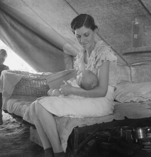 Young migrant mother with six weeks old baby born in a hospital with aid..., near Westley, CA, 1939. Creator: Dorothea Lange.