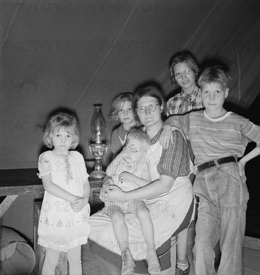 Family of six in tent after supper, FSA mobile unit, Merrill, Klamath County, Oregon, 1939 Creator: Dorothea Lange.