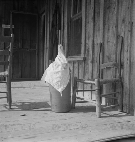 Pottery butter churn on porch of Negro tenant family, Randolph County, North Carolina, 1939. Creator: Dorothea Lange.