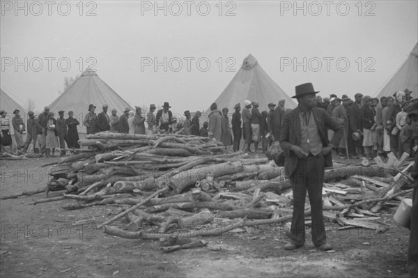 Possibly: Negroes in the lineup for food at meal time in the camp..., Forrest City, Arkansas, 1937. Creator: Walker Evans.