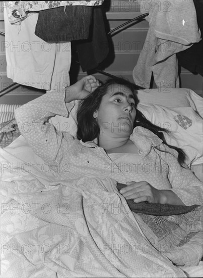 Sick woman in FSA camp for migratory agricultural workers, Tulare County, California, 1939. Creator: Dorothea Lange.