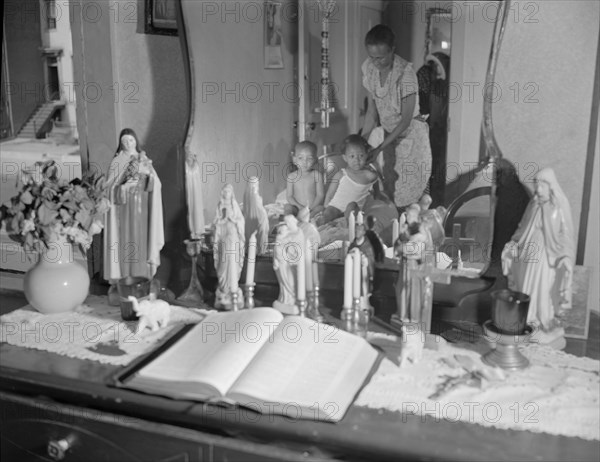 Religious objects and an improved altar in the bedroom..., Washington, D.C., 1942. Creator: Gordon Parks.