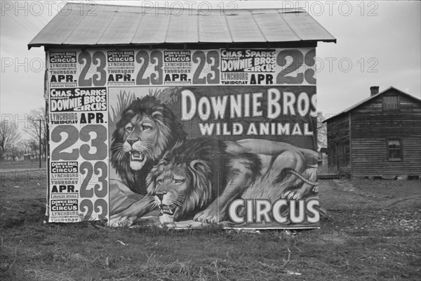 Posters covering a building near Lynchburg to advertise a Downie Bros. circus, 1936. Creator: Walker Evans.