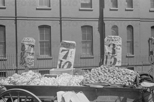 New York. New York, 61st Street between 1st and 3rd Avenues. A fruit and vegetable vendor stand.