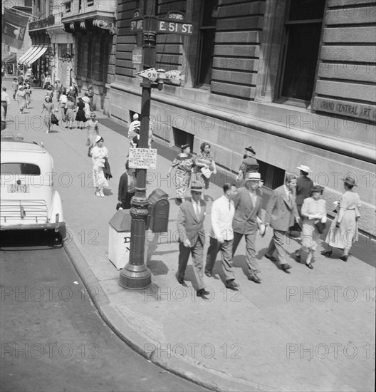 Traffic on Fifth Avenue approaching 57th Street on a summer afternoon. New York City.