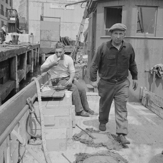 New York, New York. New England fisherman aboard their ship at Fulton fish market.