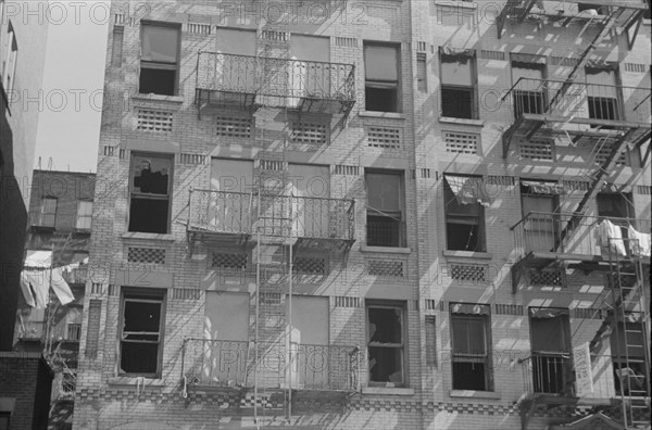 New York, New York. 61st Street between 1st and 3rd Avenues. House fronts.