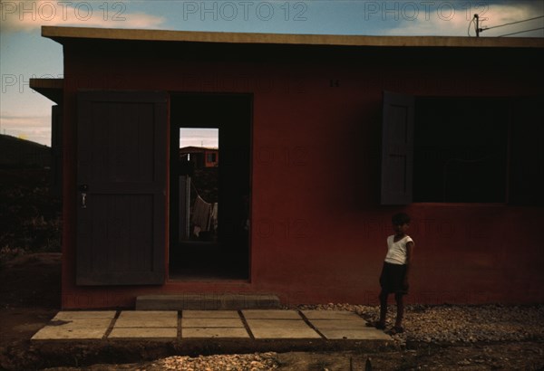 Child of an FSA - R.R. borrower? in front of their house, Puerto Rico, 1941 or 1942. Creator: Jack Delano.