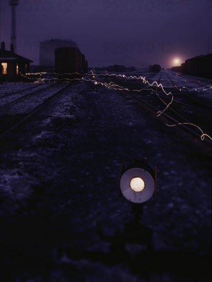 View in a departure yard at C & NW RR's Proviso (?) yard at twilight, Chicago, Ill., 1942. Creator: Jack Delano.