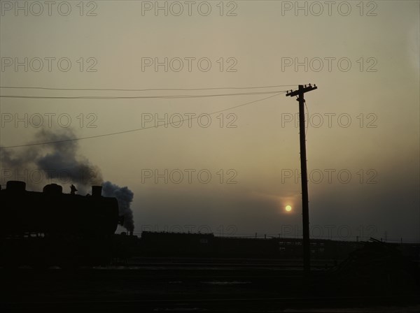 View in a departure yard at C & NW RR's Proviso (?) yard at twilight, Chicago, Ill., 1942. Creator: Jack Delano.