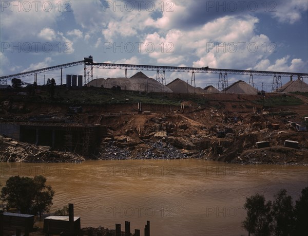 Above the construction work, the aggregate storage pile which..., Fort Loudoun Dam, Tenn., 1942. Creator: Alfred T Palmer.