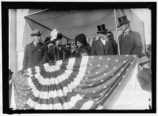 Woodrow Wilson and wife Ellen with unidentified on viewing stand, between 1910 and 1914.