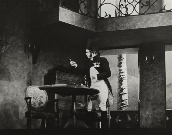 Man standing by table, 1938.