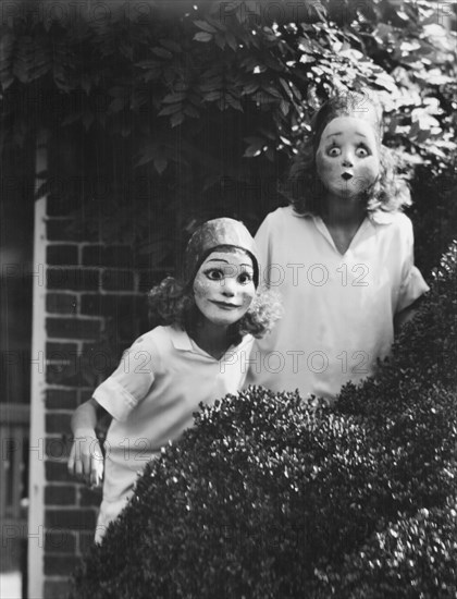 People wearing masks made by W.T. Benda, 1925 Sept. 20. Creator: Arnold Genthe.