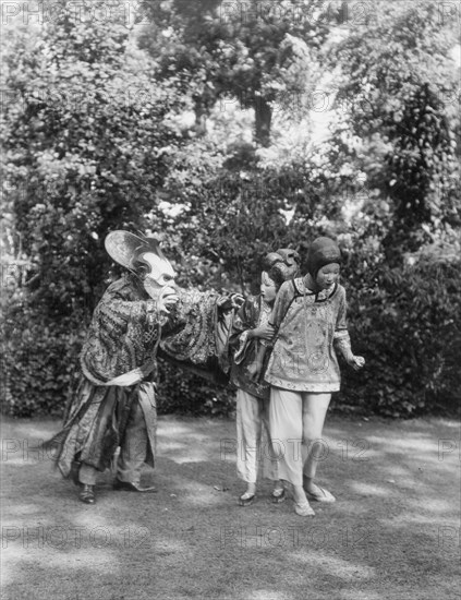 People wearing masks made by W.T. Benda, 1925 Sept. 20. Creator: Arnold Genthe.