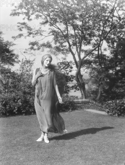 Person wearing a mask made by W.T. Benda, 1925 Sept. 20. Creator: Arnold Genthe.