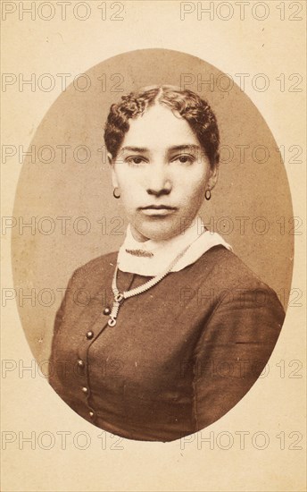 Studio portrait of young woman wearing chain necklace, c1880-c1889. Creator: Unknown.