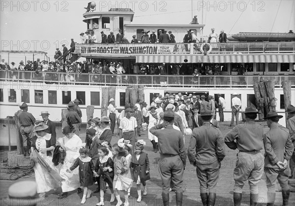 National Guard of D.C., Women And Children Leaving Boat On Return of M. And M. And N.G., 1916. Creator: Harris & Ewing.