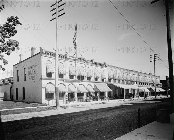 Commercial block with mineral bath house at left, probably Ypsilanti, Michigan, c1900-1910. Creator: Unknown.