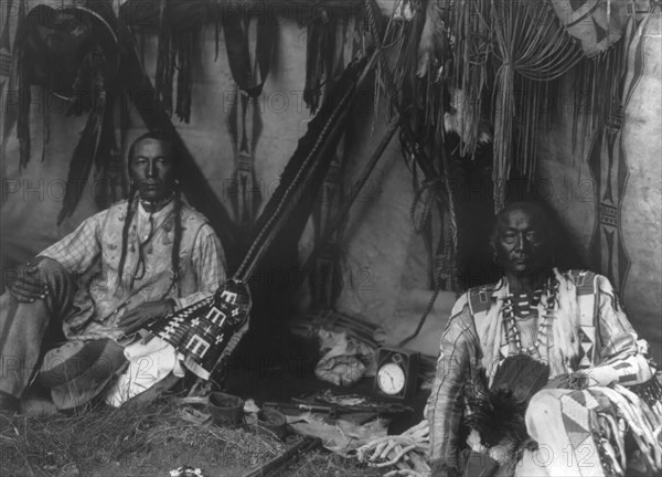 In a Piegan lodge, c1910. Creator: Edward Sheriff Curtis.