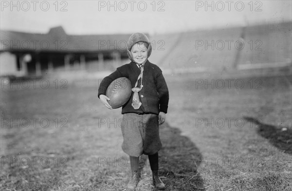 Hughey Gold [child with football], between c1910 and c1915. Creator: Bain News Service.