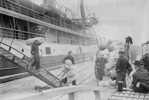 Taking Luggage off "Solace", 1914. Creator: Bain News Service.