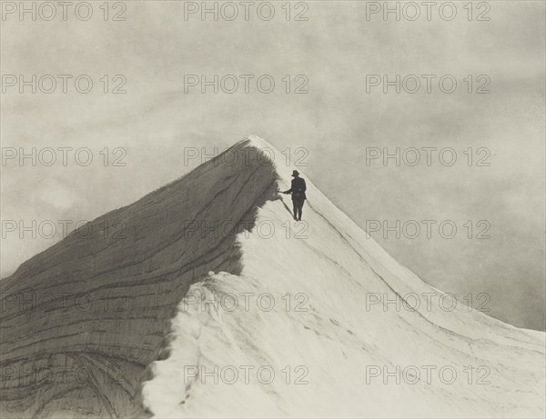 Traversing Annette wind ridge by chief guide F. Milne, Mt Cook district. From the album..., 1920s. Creator: Harry Moult.